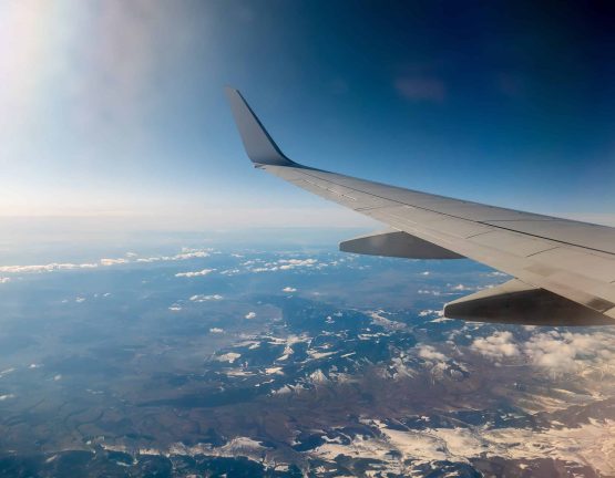 View on airplane wing and Tatry mountains by Poland side