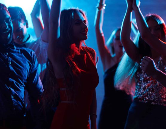 Group of cheerful friends enjoying disco